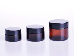 Cream jar in amber glass with black caps 